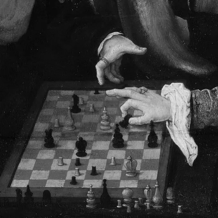 The game — hands over a chessboard