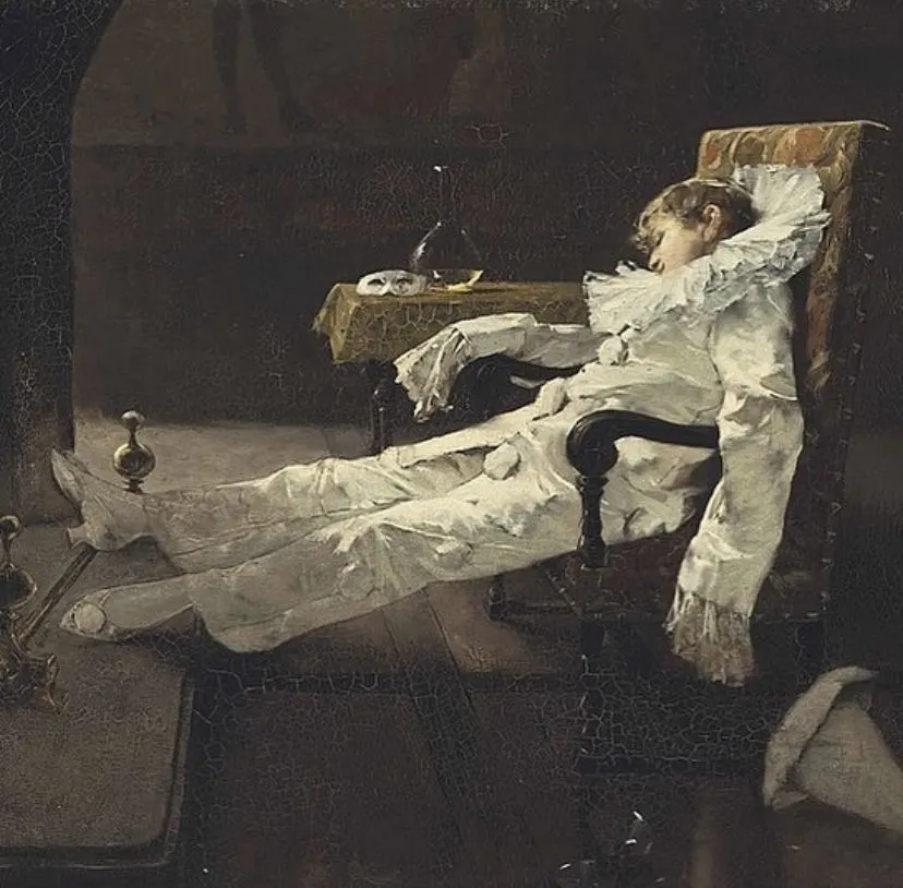 The exhausted jester — pierrot slumped in a chair
